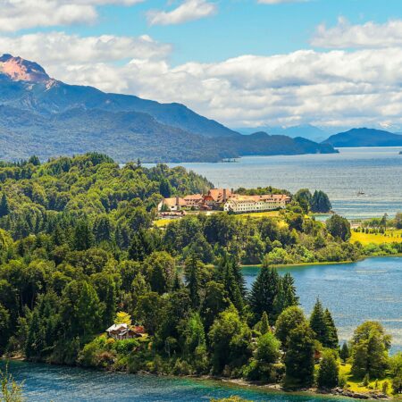 a large body of water surrounded by trees and mountains