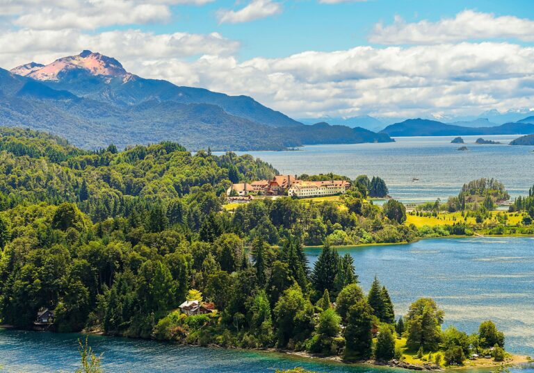 a large body of water surrounded by trees and mountains