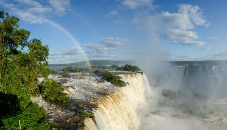 a waterfall with a rainbow